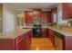 Kitchen with stainless appliances, dark wood cabinets, and granite countertops at 5840 Harrier Ln, Atlanta, GA 30349
