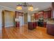 Kitchen with an island, dark wood cabinetry, and wood-look flooring at 5840 Harrier Ln, Atlanta, GA 30349