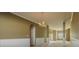 Open-concept living room with neutral paint, wainscoting, and chandelier at 5840 Harrier Ln, Atlanta, GA 30349