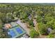 An aerial view features tennis courts, a playground, and tree-lined streets at 899 Fairwood Nw Way, Acworth, GA 30101