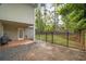 Large backyard with grass, gravel, trees, and patio area with access from the back of the house at 899 Fairwood Nw Way, Acworth, GA 30101