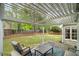 Covered backyard patio with comfortable outdoor seating, ceiling and nice backyard views at 899 Fairwood Nw Way, Acworth, GA 30101