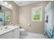 Bright bathroom featuring a large window, white fixtures and kid-friendly shower curtain at 899 Fairwood Nw Way, Acworth, GA 30101
