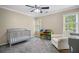 Cozy bedroom featuring a crib, rocker, and cheerful décor at 899 Fairwood Nw Way, Acworth, GA 30101