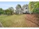 Attractive two-story home with a spacious front lawn and mature trees providing shade at 899 Fairwood Nw Way, Acworth, GA 30101