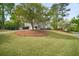 Beautifully landscaped front yard featuring a circular driveway and lush green grass at 899 Fairwood Nw Way, Acworth, GA 30101