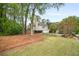 Well maintained front yard with mature trees, lawn, and a long driveway at 899 Fairwood Nw Way, Acworth, GA 30101