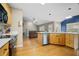 Bright kitchen with wood cabinets, stainless steel appliances, and hardwood floors flowing into the living room at 899 Fairwood Nw Way, Acworth, GA 30101