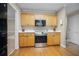Classic kitchen with light wood cabinets, stainless steel appliances, and hardwood floors at 899 Fairwood Nw Way, Acworth, GA 30101
