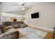 Inviting living room with a large sectional sofa, TV, hardwood floors, and neutral walls at 899 Fairwood Nw Way, Acworth, GA 30101
