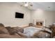 Cozy living room featuring a fireplace, hardwood floors, comfortable seating, and a ceiling fan at 899 Fairwood Nw Way, Acworth, GA 30101