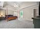 Large main bedroom with tray ceiling, soft carpet, and en-suite access at 899 Fairwood Nw Way, Acworth, GA 30101