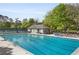 Wide view of a community pool with a bath house and lounge seating at 899 Fairwood Nw Way, Acworth, GA 30101