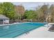 Large community pool surrounded by lounge chairs and lush greenery at 899 Fairwood Nw Way, Acworth, GA 30101