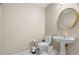 Neutral powder room featuring an oval mirror and pedestal sink at 899 Fairwood Nw Way, Acworth, GA 30101