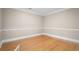 Empty room featuring hardwood floors, neutral walls with picture-frame molding, and bright trim at 899 Fairwood Nw Way, Acworth, GA 30101