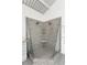 Contemporary shower with dual showerheads and glass enclosure, in a stylishly tiled bathroom at 1121 Dawn View Nw Ln, Atlanta, GA 30327