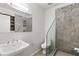 Modern bathroom with stone accent wall, frameless glass shower, and sleek vanity, offering a luxurious retreat at 1121 Dawn View Nw Ln, Atlanta, GA 30327