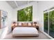 Bright bedroom with a large window that looks out to a lush green space, with a cozy king bed at 1121 Dawn View Nw Ln, Atlanta, GA 30327