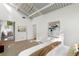 Bright bedroom with a large window that looks out to a lush green space and vaulted ceilings at 1121 Dawn View Nw Ln, Atlanta, GA 30327