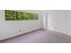 Bright bedroom with a large window and scenic forest views, providing a tranquil and airy atmosphere at 1121 Dawn View Nw Ln, Atlanta, GA 30327