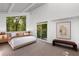 Bright bedroom with a large window that looks out to a lush green space, with a cozy king bed at 1121 Dawn View Nw Ln, Atlanta, GA 30327