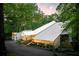 Stunning home exterior featuring a modern design with a white roof and lush surrounding trees at 1121 Dawn View Nw Ln, Atlanta, GA 30327