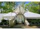 Contemporary home's front entrance boasts a unique glass door and manicured landscaping at 1121 Dawn View Nw Ln, Atlanta, GA 30327