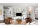 Bright living room showcases stylish seating, glass shelving, and scenic outdoor views at 1121 Dawn View Nw Ln, Atlanta, GA 30327