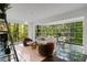 An open-concept living area with floor to ceiling windows, stylish seating, and dark, reflective flooring at 1121 Dawn View Nw Ln, Atlanta, GA 30327