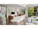Open living room with floor-to-ceiling windows and sleek shelving is perfect for relaxing and entertaining at 1121 Dawn View Nw Ln, Atlanta, GA 30327