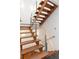 Modern wood staircase with glass railing, showcasing a sleek design and natural light at 1121 Dawn View Nw Ln, Atlanta, GA 30327