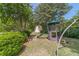 Large backyard with a play structure, lawn and mature trees at 1924 Windburn Ct, Snellville, GA 30078