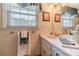 Bathroom featuring a vanity with sink, decorative light fixture and window with shades at 1924 Windburn Ct, Snellville, GA 30078