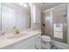 Bathroom featuring a sink, toilet, shower with sliding glass doors, and white cabinets at 1924 Windburn Ct, Snellville, GA 30078
