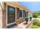 Close-up of the beautiful brick exterior, ornate glass front door, and meticulously cared-for landscaping at 1924 Windburn Ct, Snellville, GA 30078