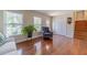 Inviting living room with large windows, hardwood floors, and a comfortable chair near the staircase at 1924 Windburn Ct, Snellville, GA 30078