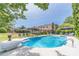 Beautiful pool with a diving board, lounge seating and lush landscaping creating a relaxing backyard oasis at 1924 Windburn Ct, Snellville, GA 30078