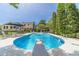 Gorgeous pool with diving board, lounge seating, manicured lawn, and backyard scenery at 1924 Windburn Ct, Snellville, GA 30078