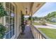 Inviting porch with traditional railing, decorative hanging lantern, and verdant green scenery at 1924 Windburn Ct, Snellville, GA 30078