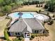Aerial view of community clubhouse, pool, and surrounding green space, offering a picturesque lifestyle at 3875 Grandview Manor Dr, Cumming, GA 30028
