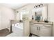 Bathroom with soaking tub, granite countertop vanity, and a large mirror reflecting the glass shower at 3875 Grandview Manor Dr, Cumming, GA 30028
