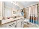 Well-lit bathroom with granite countertops, white cabinets, and a shower/tub combination with a curtain at 3875 Grandview Manor Dr, Cumming, GA 30028