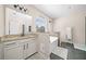 Bright bathroom with granite countertops, a large mirror, and a standalone tub at 3875 Grandview Manor Dr, Cumming, GA 30028