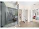 Modern bathroom with a large glass shower, tile floors, and access to a bedroom and walk-in closet at 3875 Grandview Manor Dr, Cumming, GA 30028