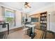 Bright bedroom featuring a large window, ceiling fan, custom barn doors, and hardwood floors at 3875 Grandview Manor Dr, Cumming, GA 30028