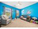 Bright bedroom with a crib, an accent wall, and lots of toys for  at 3875 Grandview Manor Dr, Cumming, GA 30028