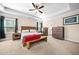 Spacious bedroom with tray ceilings, a ceiling fan, and a full sized bed at 3875 Grandview Manor Dr, Cumming, GA 30028
