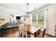 Open-concept dining area with hardwood floors, chandelier, adjacent to living room at 3875 Grandview Manor Dr, Cumming, GA 30028