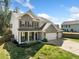 Side view of the two-story house with brick and siding exterior, three-car garage, and beautifully landscaped front yard at 3875 Grandview Manor Dr, Cumming, GA 30028